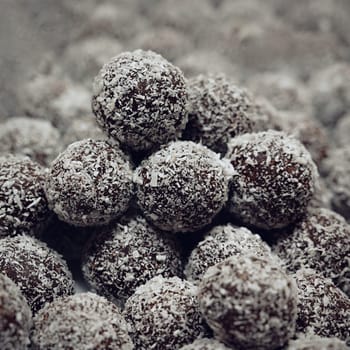 Rum balls in coconut. Traditional unbaked Czech sweets for Christmas and winter. Raw sweet food with cocoa and coconut.