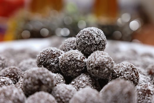 Rum balls in coconut. Traditional unbaked Czech sweets for Christmas and winter. Raw sweet food with cocoa and coconut.