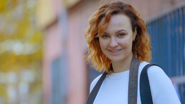 A young walking photographer. Action.A beautiful woman with a camera in her hands who turns and smiles. High quality 4k footage