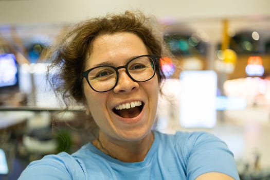 Video call portrait of excited cheerful smiling woman in spectacles taking selfie photo. Selfie and blogger