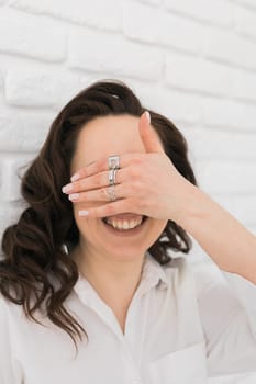 Women Jewelry concept. Woman's hands close up wearing rings and necklace modern accessories elegant lifestyle. Funny girl.