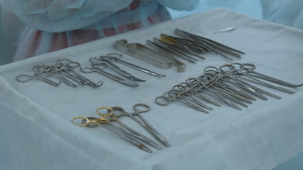 Close up shot of table with professional surgical instruments. Action. Modern sterile medical facility