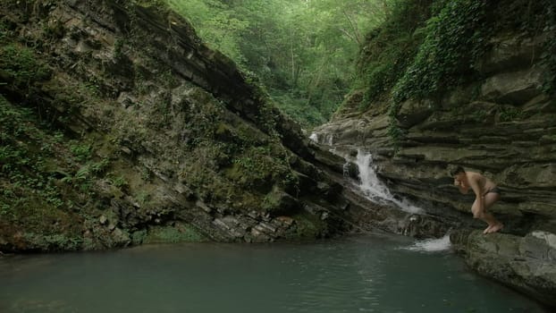 A walk on the rocks with a gushing stream. Creative.Small waterfalls with cold water where tourists swim and walk. High quality 4k footage