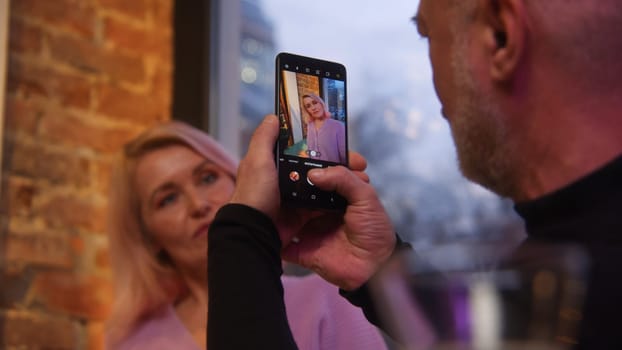 Elderly couple on date in restaurant. Stock footage. Beautiful elderly couple is having nice time on date. Elderly couple on date at restaurant in evening.