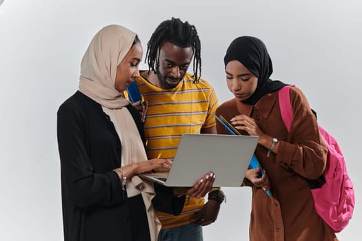 A group of students, including an African American student and two hijab-wearing women, stand united against a pristine white background, symbolizing a harmonious blend of cultures and backgrounds in the pursuit of knowledge and academic excellence.