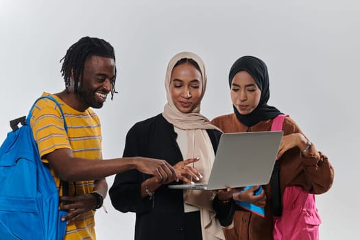 A group of students, including an African American student and two hijab-wearing women, stand united against a pristine white background, symbolizing a harmonious blend of cultures and backgrounds in the pursuit of knowledge and academic excellence.