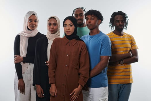 In a vibrant display of educational diversity, a group of students strikes a pose against a clean white background, holding backpacks, laptops, and tablets, symbolizing a blend of modern technology, unity, and cultural inclusivity in their academic journey.