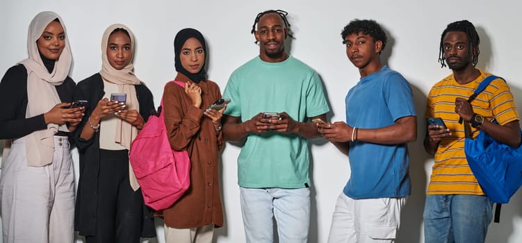 A diverse group of students, immersed in the digital age, stands united while engaging with their smartphones against a white backdrop, symbolizing the modern era of connectivity, communication, and collaborative learning.