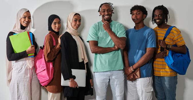 In a vibrant display of educational diversity, a group of students strikes a pose against a clean white background, holding backpacks, laptops, and tablets, symbolizing a blend of modern technology, unity, and cultural inclusivity in their academic journey.