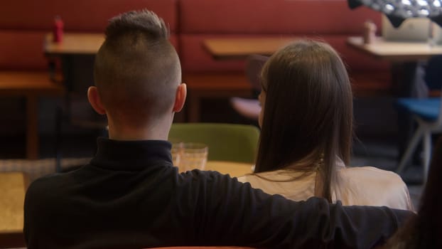 Beautiful young couple on date in cafe. Stock footage. Young couple is having nice time on date in cafe. Date of young couple in cafe.
