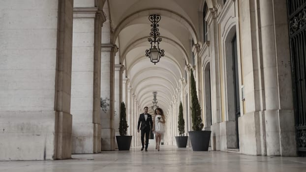 A walking couple of running newlyweds. Action. A large castle next to which people are running with flowers and happy faces in wedding dresses. High quality 4k footage