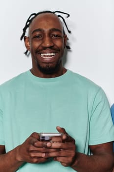 African American teenager engages with his smartphone against a pristine white background, encapsulating the essence of contemporary digital connectivity and youth culture.