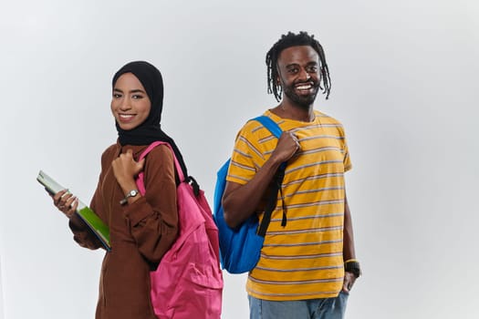 Against a clean white background, two students, an African American young man and a hijab-wearing woman, collaboratively use laptops in a display of technological empowerment and inclusive education, embodying the unity and diversity within the academic journey.