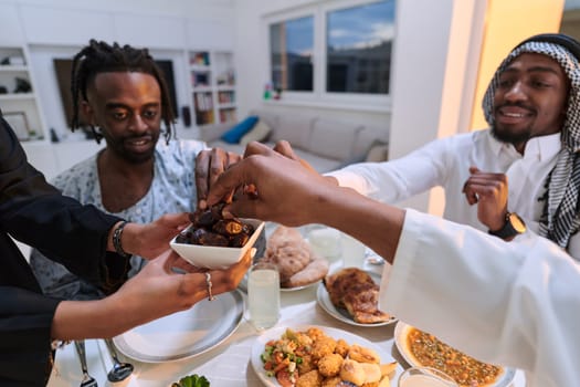 In a poignant close-up, the diverse hands of a Muslim family delicately grasp fresh dates, symbolizing the breaking of the fast during the holy month of Ramadan, capturing a moment of cultural unity, shared tradition, and the joyous anticipation of communal iftar.