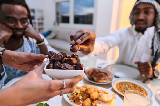 In a poignant close-up, the diverse hands of a Muslim family delicately grasp fresh dates, symbolizing the breaking of the fast during the holy month of Ramadan, capturing a moment of cultural unity, shared tradition, and the joyous anticipation of communal iftar.