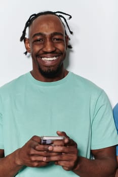 African American teenager engages with his smartphone against a pristine white background, encapsulating the essence of contemporary digital connectivity and youth culture.