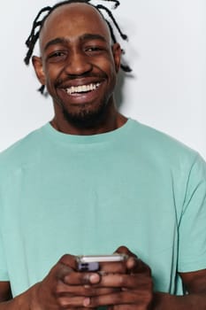 African American teenager engages with his smartphone against a pristine white background, encapsulating the essence of contemporary digital connectivity and youth culture.