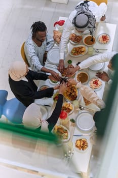 Top view of diverse hands of a Muslim family delicately grasp fresh dates, symbolizing the breaking of the fast during the holy month of Ramadan, capturing a moment of cultural unity, shared tradition, and the joyous anticipation of communal iftar.