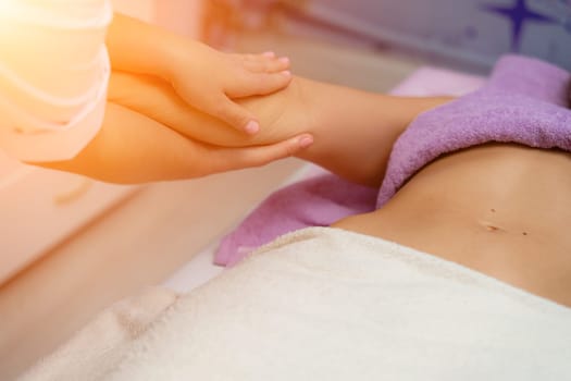 Blonde massage therapist massaging a woman. Woman getting a massage at the spa.