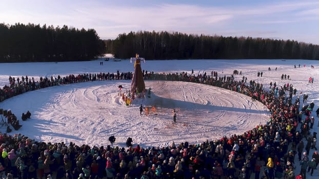 Moscow, Russia - February 26, 2018: Russian traditional celebration Maslenitsa. People celebrate Maslenitsa and relax in countryside. Burning Scarecrow.