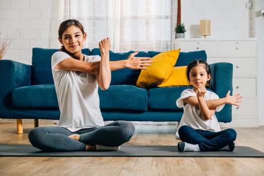 A mother and her daughter share a heartwarming gym session emphasizing stretching and yoga creating a harmonious family moment filled with togetherness balance and happiness.