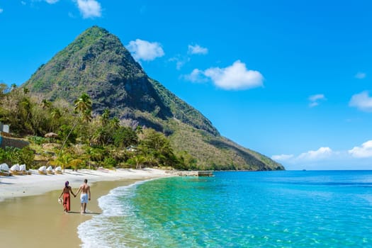 Young couple men and women on vacation in Saint Lucia, luxury holiday Saint Lucia Caribbean, Asian women and Caucasian men on vacation at the tropical Island of Saint Lucia Caribbean