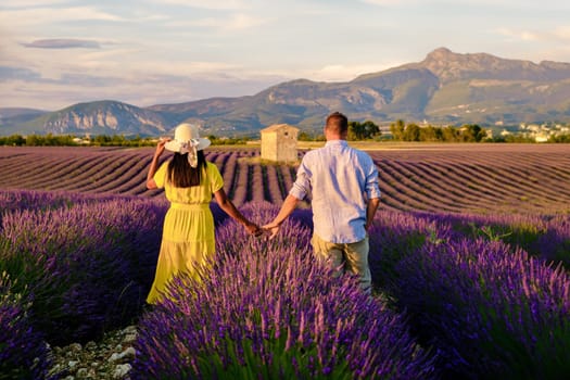 Valensole Provence France, a colorful field of Lavender in bloom Provence Southern France Couple men and women on vacation at the Provence Southern France walking in a lavender field