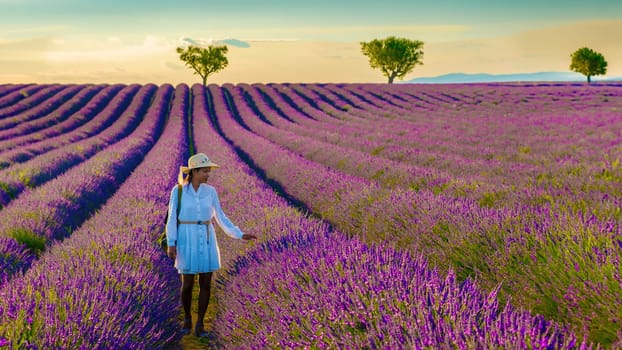 Valensole Provence France, a colorful field of Lavender in bloom Provence Southern France women on vacation at the Provence Southern France walking in a lavender field