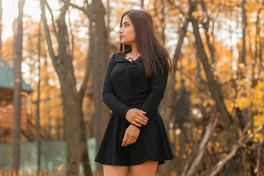 Close up portrait of pretty indian young woman enjoying warm autumn sunny day vacation outdoors. Generation z and gen z concept. Fall Season.