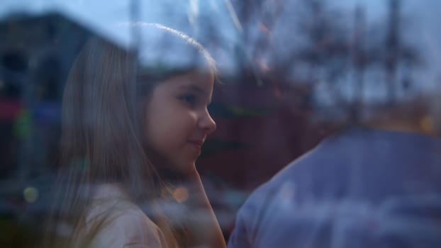 Boy and girl are talking in cafe. Stock footage. Cute couple of kids are sitting in cafe. Children chat sweetly together in cafe. Childhood infatuation.