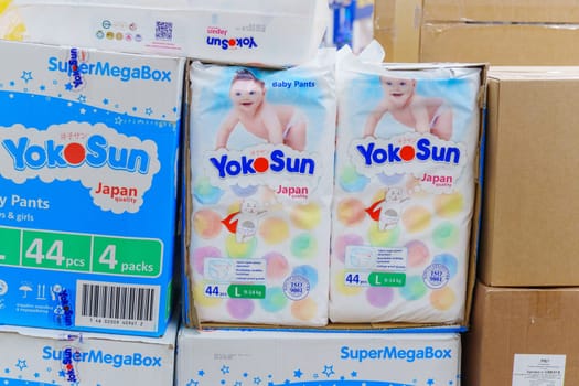 Tyumen, Russia-November 25, 2023: Buying baby diapers pants YokoSun in the supermarket.