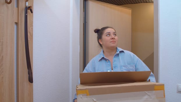 A beautiful woman entering the apartment. Media. A pretty woman with her own hair who enters her apartment. High quality 4k footage