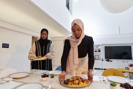 Group of young Arab women come together to lovingly prepare an iftar table during the sacred Muslim month of Ramadan, embodying the essence of communal unity, cultural tradition, and joyous anticipation in their culinary preparations.