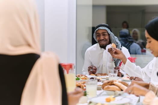 A traditional and diverse Muslim family comes together to share a delicious iftar meal during the sacred month of Ramadan, embodying the essence of familial joy, cultural richness, and spiritual unity in their shared celebration.