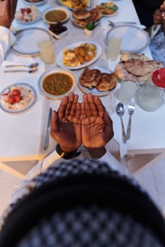 In the sacred month of Ramadan, a diverse Muslim family comes together in spiritual unity, fervently praying to God before breaking their fast, capturing a moment of collective devotion, cultural diversity, and familial joy in the midst of the holy celebration.