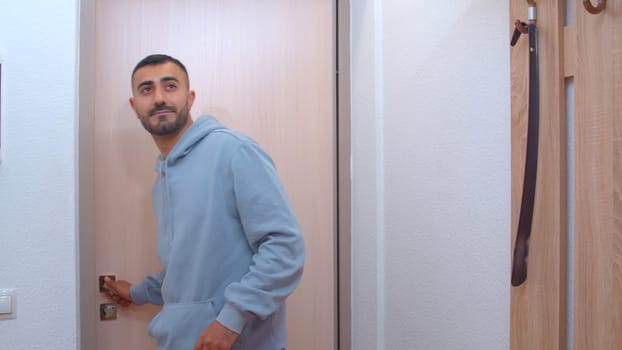 The courier brought the package. Media. An adult handsome man in oversize clothes brought boxes to a new apartment. High quality 4k footage
