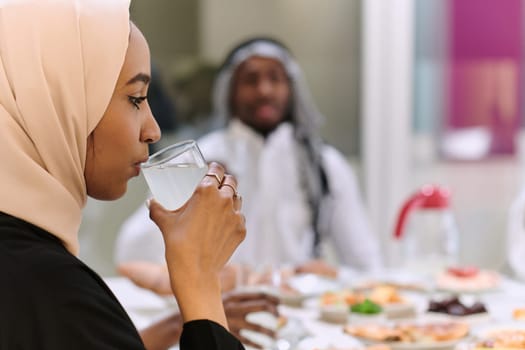 A traditional and diverse Muslim family comes together to share a delicious iftar meal during the sacred month of Ramadan, embodying the essence of familial joy, cultural richness, and spiritual unity in their shared celebration.