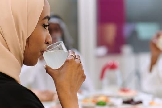 A traditional and diverse Muslim family comes together to share a delicious iftar meal during the sacred month of Ramadan, embodying the essence of familial joy, cultural richness, and spiritual unity in their shared celebration.