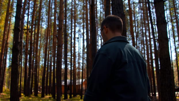 Sad lonely man in summer forest thinking of life. Stock footage. Thoughtful male spending time alone