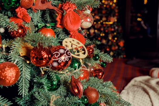 Christmas decorations on the holiday tree.Many colorful balls garland glowing lamps and red berries on the branches are sprinkled with snow.