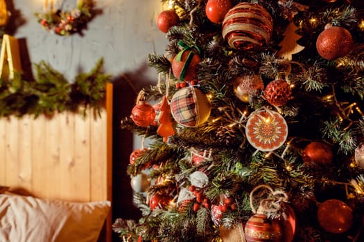 Christmas decorations on the holiday tree.Many colorful balls garland glowing lamps and red berries on the branches are sprinkled with snow.