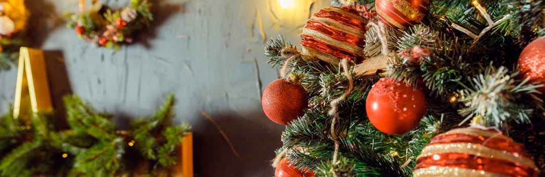 Christmas decorations on the holiday tree.Many colorful balls garland glowing lamps and red berries on the branches are sprinkled with snow.