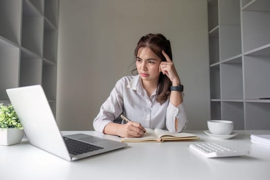 Businesswoman is stressed and tired from working all day at the office..