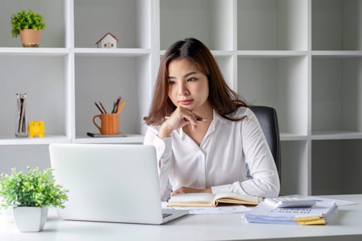 Businesswoman is stressed and tired from working all day at the office..