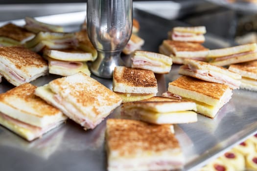 Toast with ham and cheese, served as appetizer.
Events. Party.