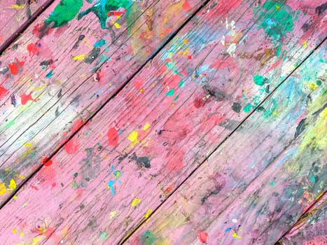 Wooden table colorful paint background. Multicolor