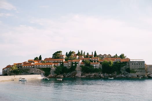 Boats are moored off the island of Sveti Stefan. Montenegro. High quality photo