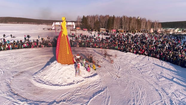 Moscow, Russia - February 26, 2018: Russian traditional celebration Maslenitsa. People celebrate Maslenitsa and relax in countryside. Burning Scarecrow.