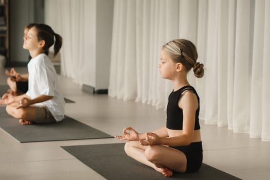 Children do Yoga in the fitness room. Children's gymnastics..