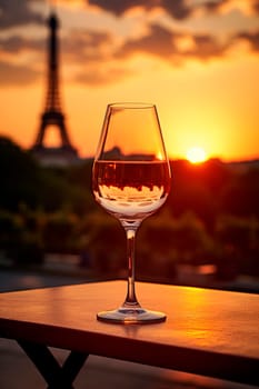 Glass of wine sunset Eiffel Tower background. Selective focus. Holiday.